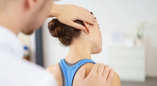 a woman receiving sports therapy for neck pain